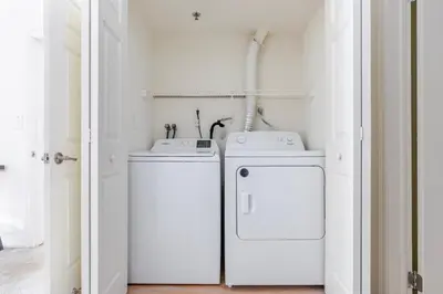 a laundry room with two washer and dryer at Blueground Hudson Exchange pool nr Liberty Park NYC-2222 in New York