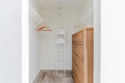 a closet with a wooden dresser in a room at Blueground Hudson Exchange pool nr Liberty Park NYC-2222 in New York