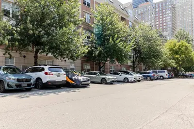 a row of cars parked on the side of a street at Blueground Hudson Exchange pool nr Liberty Park NYC-2222 in New York