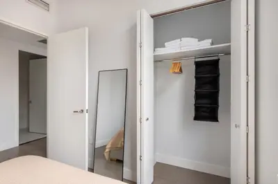 a bedroom with a mirror and a closet at Blueground Gramercy Park rooftop nr Flatiron NYC-2203 in New York