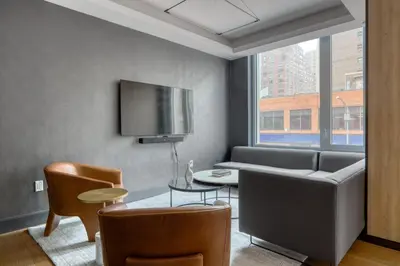 a living room with a couch and a table at Blueground Gramercy Park rooftop nr Flatiron NYC-2203 in New York