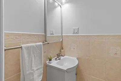 a bathroom with a toilet and a sink and a mirror at Group Retreat 15Min to NYC, MetLife, Mall, FREE Pa in North Bergen