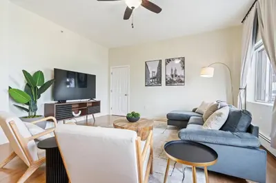 a living room with a couch and a tv at Group Retreat 15Min to NYC, MetLife, Mall, FREE Pa in North Bergen