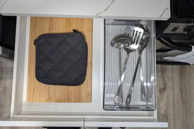 a cabinet with utensils in a kitchen at Spacious 2BR - 15m to Times Square - FREE Parking in North Bergen