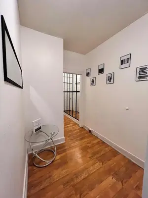 an empty room with a glass table on a wooden floor at Charming 2 bedroom apartment in Philadelphia