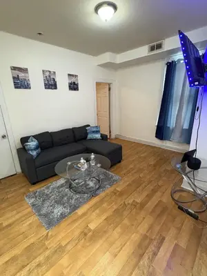 a living room with a couch and a table at Charming 2 bedroom apartment in Philadelphia