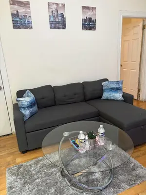 a living room with a couch and a glass table at Charming 2 bedroom apartment in Philadelphia
