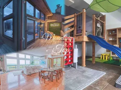 a house with a playground with a slide at Mountain Top! Family Paradise w Hot Tub & Game Rm in Tannersville