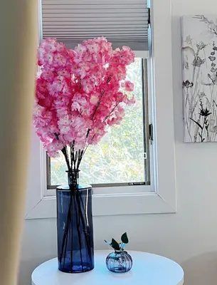 a blue vase with pink flowers in a window at Mountain Top! Family Paradise w Hot Tub & Game Rm in Tannersville