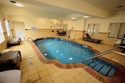 a large swimming pool in a large room at Express Inn & Suites in Harrisburg