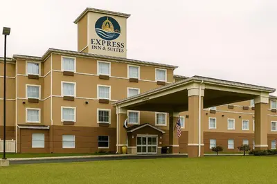 a large building with a sign on top of it at Express Inn & Suites in Harrisburg