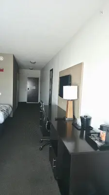 a hotel room with a desk with a lamp and a bed at Express Inn & Suites in Harrisburg