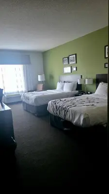 a hotel room with two beds and a window at Express Inn & Suites in Harrisburg