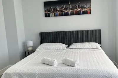 a bed with two white pillows on top of it at 2Bed Gem-15min to NYC-3min Walk to Bus-Train in North Bergen