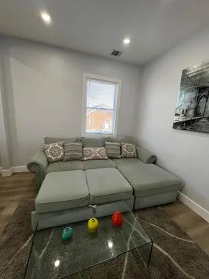 a living room with a couch and a glass table at 2Bed Gem-15min to NYC-3min Walk to Bus-Train in North Bergen