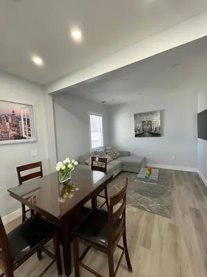 a living room with a table and a couch at 2Bed Gem-15min to NYC-3min Walk to Bus-Train in North Bergen