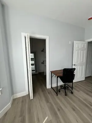 a room with a table and a chair and a mirror at 2Bed Gem-15min to NYC-3min Walk to Bus-Train in North Bergen