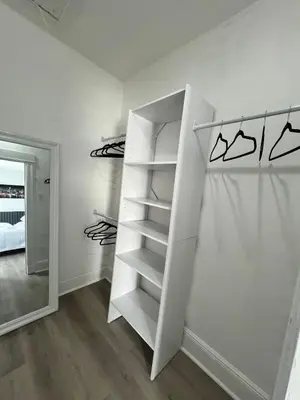a walk in closet with white shelves at 2Bed Gem-15min to NYC-3min Walk to Bus-Train in North Bergen