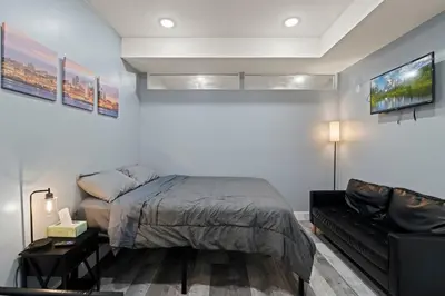 a bedroom with a bed and a couch at Cozy Convenient 1 Bedroom with 2 Beds Near Downtown in Philadelphia