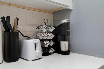 a kitchen counter with a toaster oven and cupcakes at Cozy Convenient 1 Bedroom with 2 Beds Near Downtown in Philadelphia