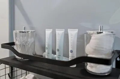 a shelf with four glass vases on it at Cozy Convenient 1 Bedroom with 2 Beds Near Downtown in Philadelphia