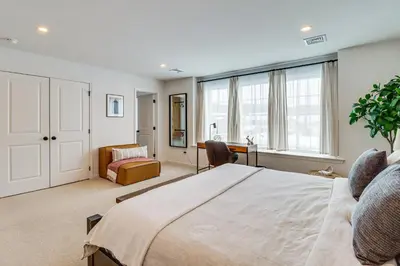 a bedroom with a large bed and a desk at Half-Mi to the Triangle! Chic Emmaus Townhome