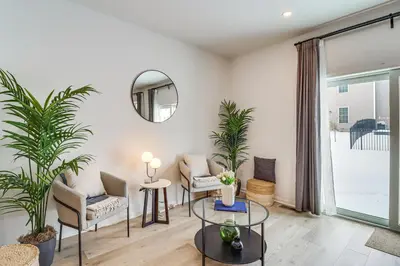 a living room with plants and a mirror at Half-Mi to the Triangle! Chic Emmaus Townhome
