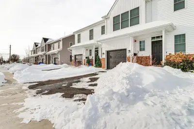 a pile of snow in front of a house at Half-Mi to the Triangle! Chic Emmaus Townhome