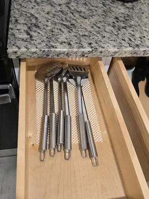 a row of knives hanging from a kitchen counter at Stylish 3BR Retreat Near EWR Airport NYC Hub in Newark
