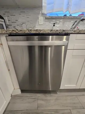 a stainless steel dishwasher in a kitchen at Stylish 3BR Retreat Near EWR Airport NYC Hub in Newark