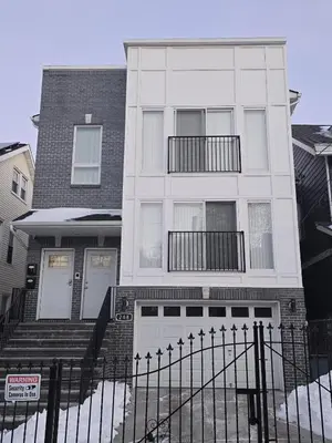 a white house with a fence in front of it at Stylish 3BR Retreat Near EWR Airport NYC Hub in Newark