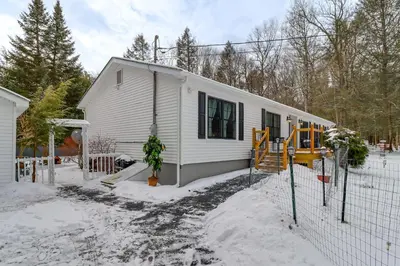 a white house in the snow with a fence at Family-Friendly Home 6 Mi to Big Boulder Mtn! in Albrightsville