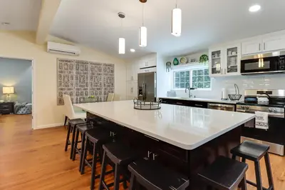 a kitchen with a large white counter top and chairs at Family-Friendly Home 6 Mi to Big Boulder Mtn! in Albrightsville