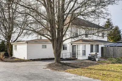 a white house with a tree in a driveway at Family-Friendly Home, 5 Mi to Roundtop Mtn Resort! in Dillsburg