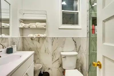a bathroom with a toilet and a sink at Easy NYC Access! Gateway Region Apartment with Yard in West New York