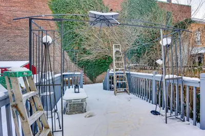 a metal arch with snow on it and a ladder at Easy NYC Access! Gateway Region Apartment with Yard in West New York