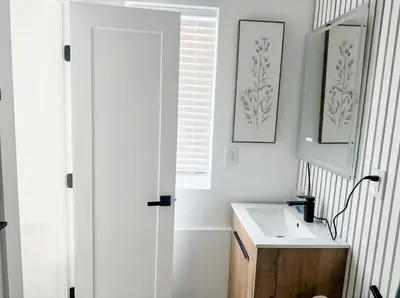 a white bathroom with a sink and a mirror at Furnished Private room with shared spaces in Jersey City