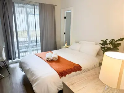 a bedroom with a bed with two towels on it at Furnished Private room with shared spaces in Jersey City