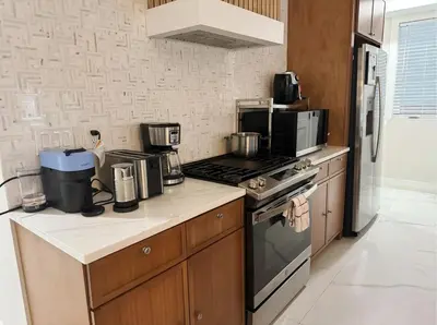 a kitchen with a stove and a microwave at Furnished Private room with shared spaces in Jersey City