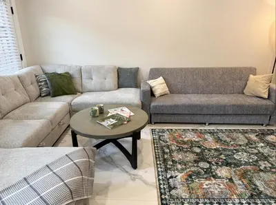 a living room with two couches and a coffee table at Furnished Private room with shared spaces in Jersey City