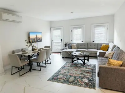 a living room with a couch and a table at Furnished Private room with shared spaces in Jersey City