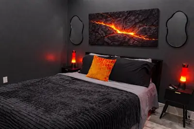 a bedroom with a bed with two lamps and a painting on the wall at Midnight Ember Moody City 1BR Escape in Philadelphia