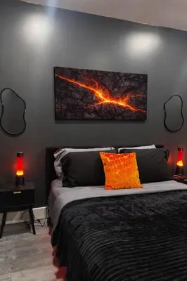 a bedroom with a bed with a painting on the wall at Midnight Ember Moody City 1BR Escape in Philadelphia