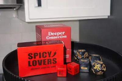 a table with two boxes and dice on it at Midnight Ember Moody City 1BR Escape in Philadelphia