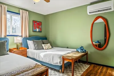 a bedroom with two beds and a mirror at Movie Theater Game Room Resort Amenity Access in Tobyhanna