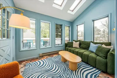 a living room with a couch and a table at Movie Theater Game Room Resort Amenity Access in Tobyhanna