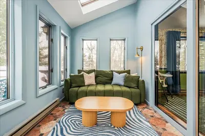 a living room with a couch and a table at Movie Theater Game Room Resort Amenity Access in Tobyhanna