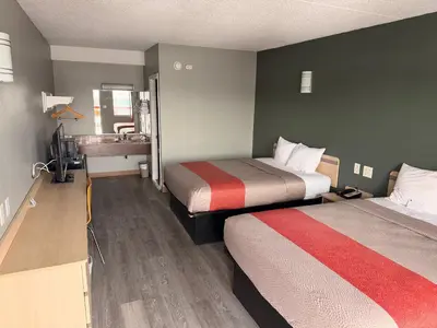 a hotel room with two beds and a sink at Value Extended Stay in Maple Shade