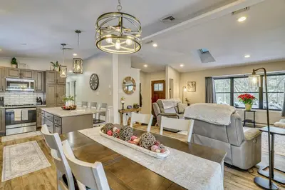 a kitchen and living room with a table and chairs at Newly Renovated! Peaceful Saylorsburg Home in Saylorsburg