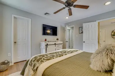 a bedroom with a bed with a ceiling fan at Newly Renovated! Peaceful Saylorsburg Home in Saylorsburg